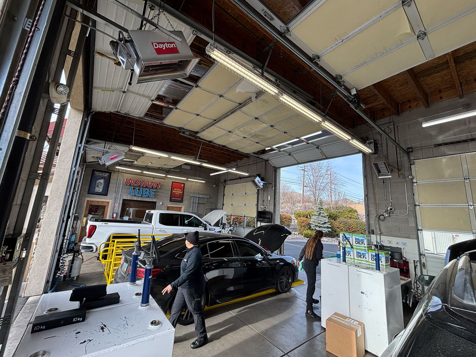 Technicians in Instant Lube performing oil changes